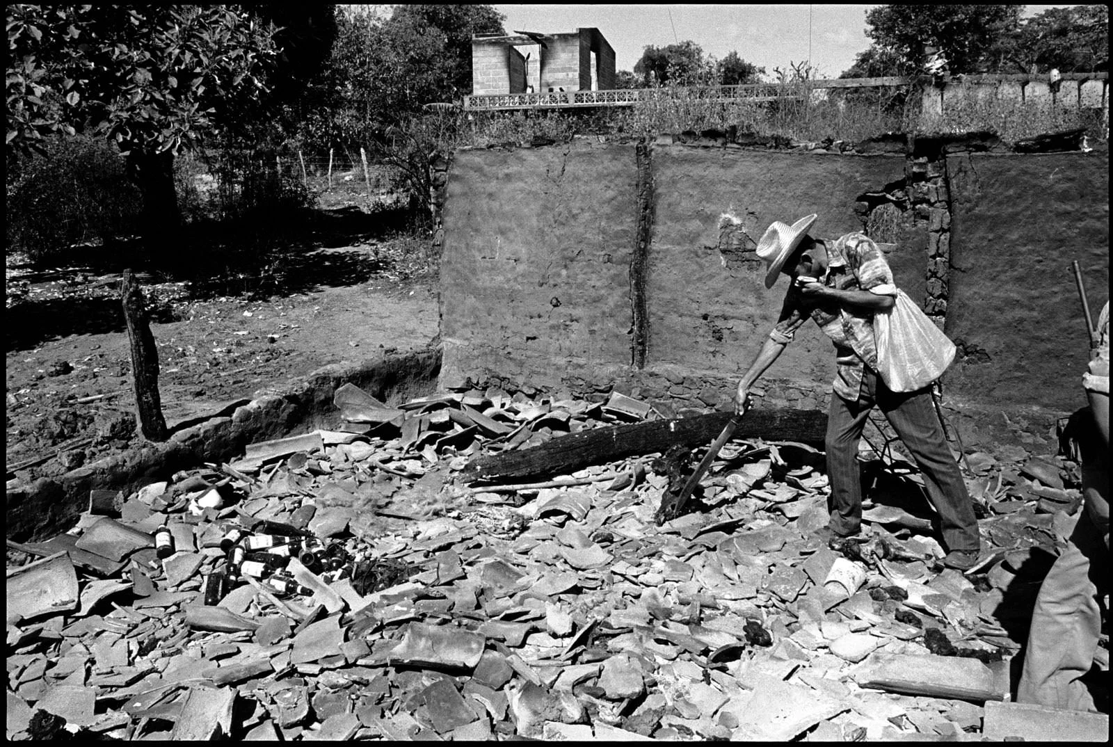 A man looks through the remains of a church in El Mozote in January of 1982, months after the massacre