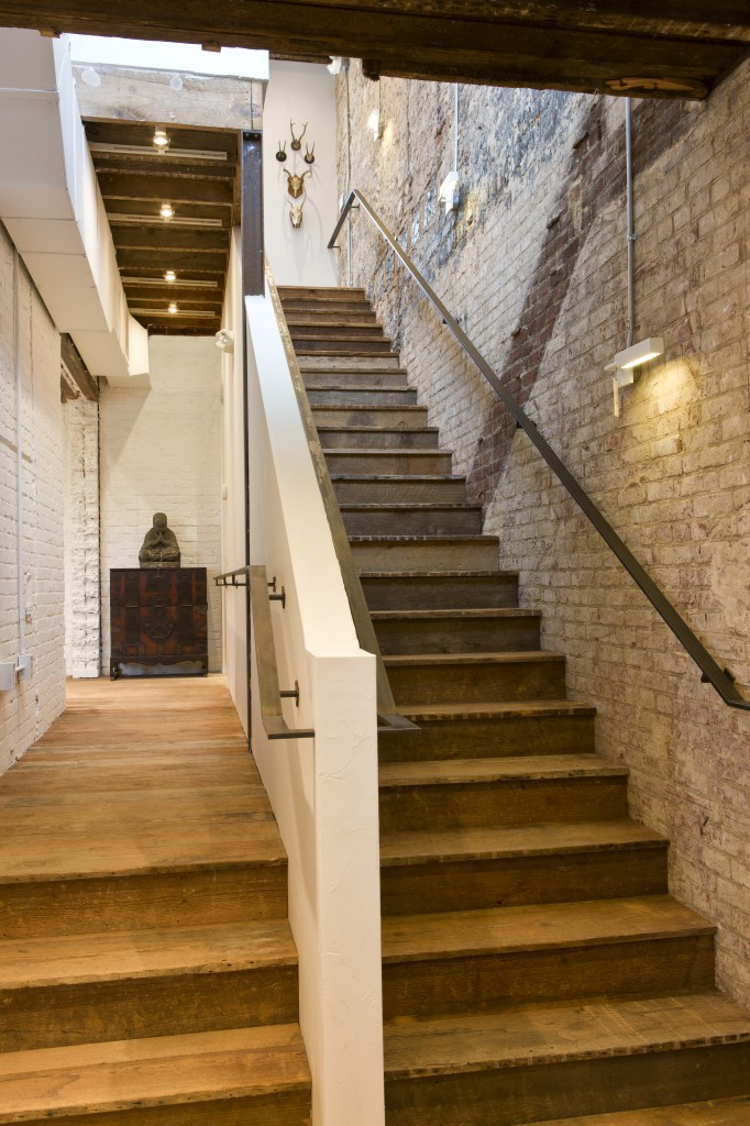 Reclaimed wood converted for reuse for boutique flooring, trim, trusses and staircases.