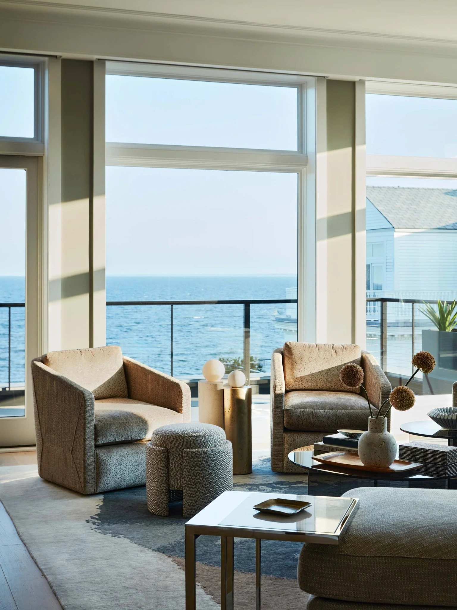 Bathed in natural light and framed by ocean views, this coastal living room captures calm through tone, texture, and proportion. Layered neutrals anchor the space, while sculptural furnishings and artful accents bring quiet movement. 
Photography: @
