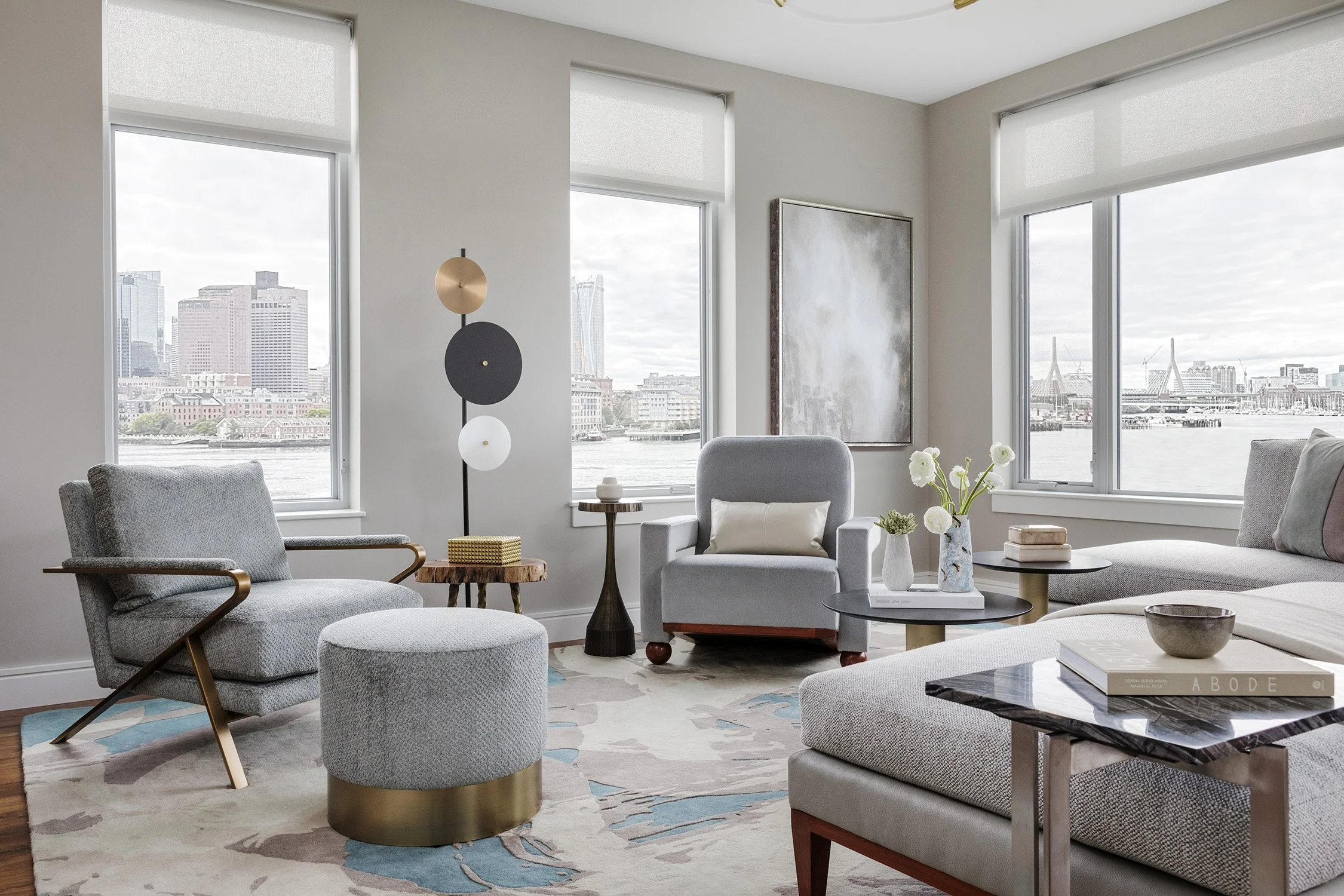 elevated-eastie-modern-interior-waterfront-living-room-gray-seating-gold-accents-boston-view-trevor-fulmer.jpg