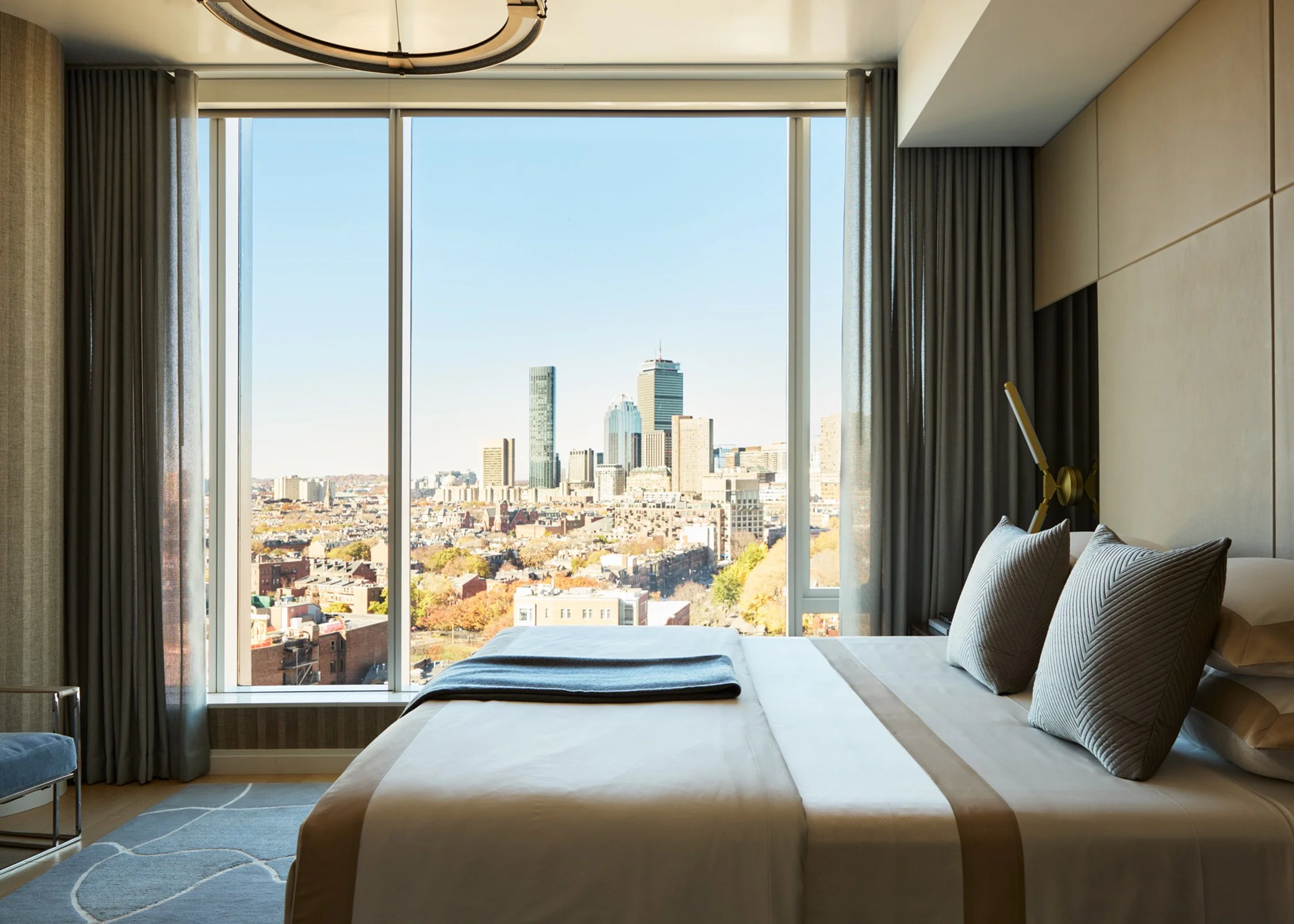 Skyline sophistication primary bedroom custom furniture and rugs interior design by Trevor Fulmer