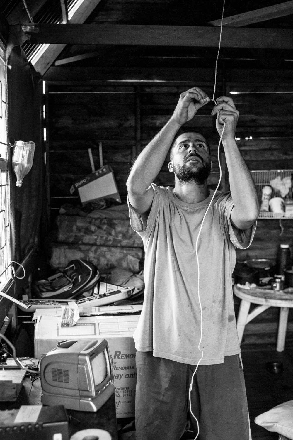  Stephen, Danie's brother has been living with him for a few months. Here he was busy helping his brother to wire up a light bulb from a small solar panel that was donated. 