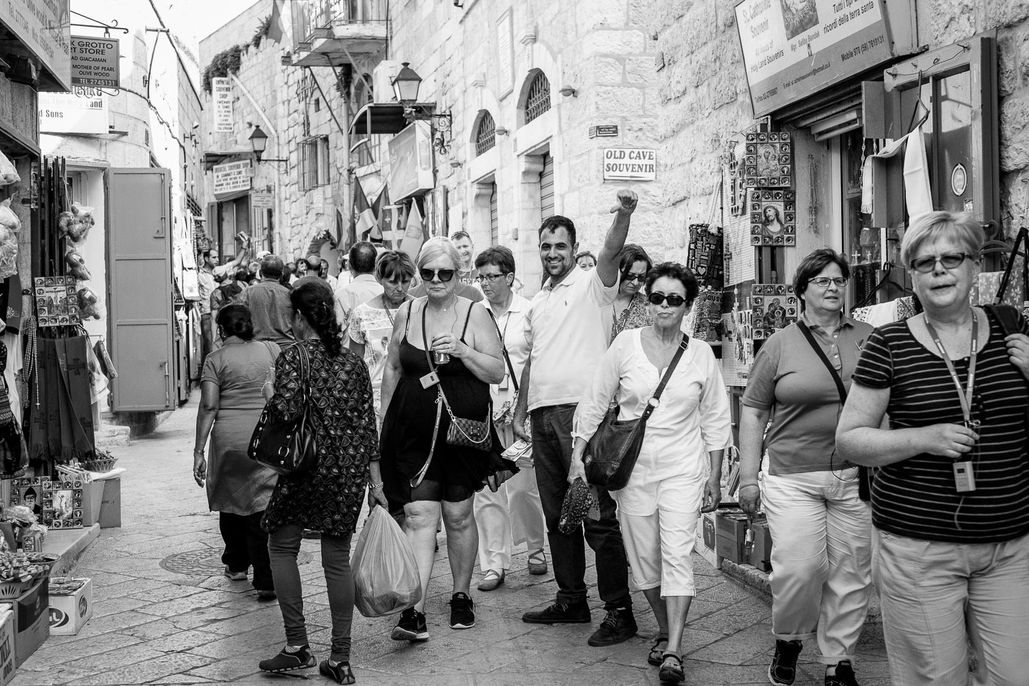 Saliba outside his store whilst tourist are walking past.