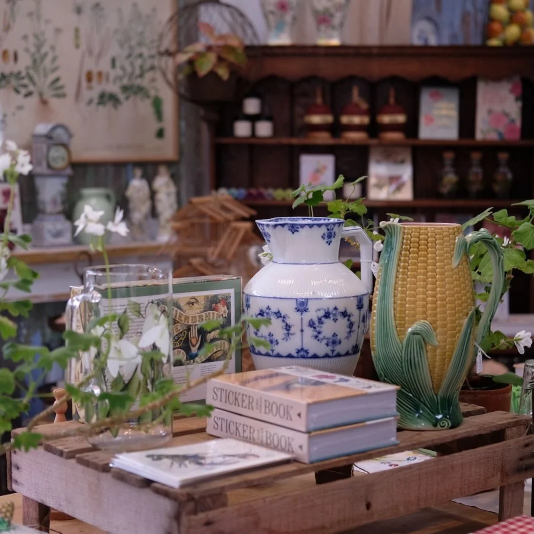 A table of treasures vintage jugs, blooming geraniums, sticker books and garden dreams. Come get lost in the details 🌿📚🪴

Open 10-4 Wednesday to Sunday 

#ShopSmall #VintageStyle #BotanicalHome #InteriorsInspo #CottagecoreVibes #AntiqueLovers #Pla