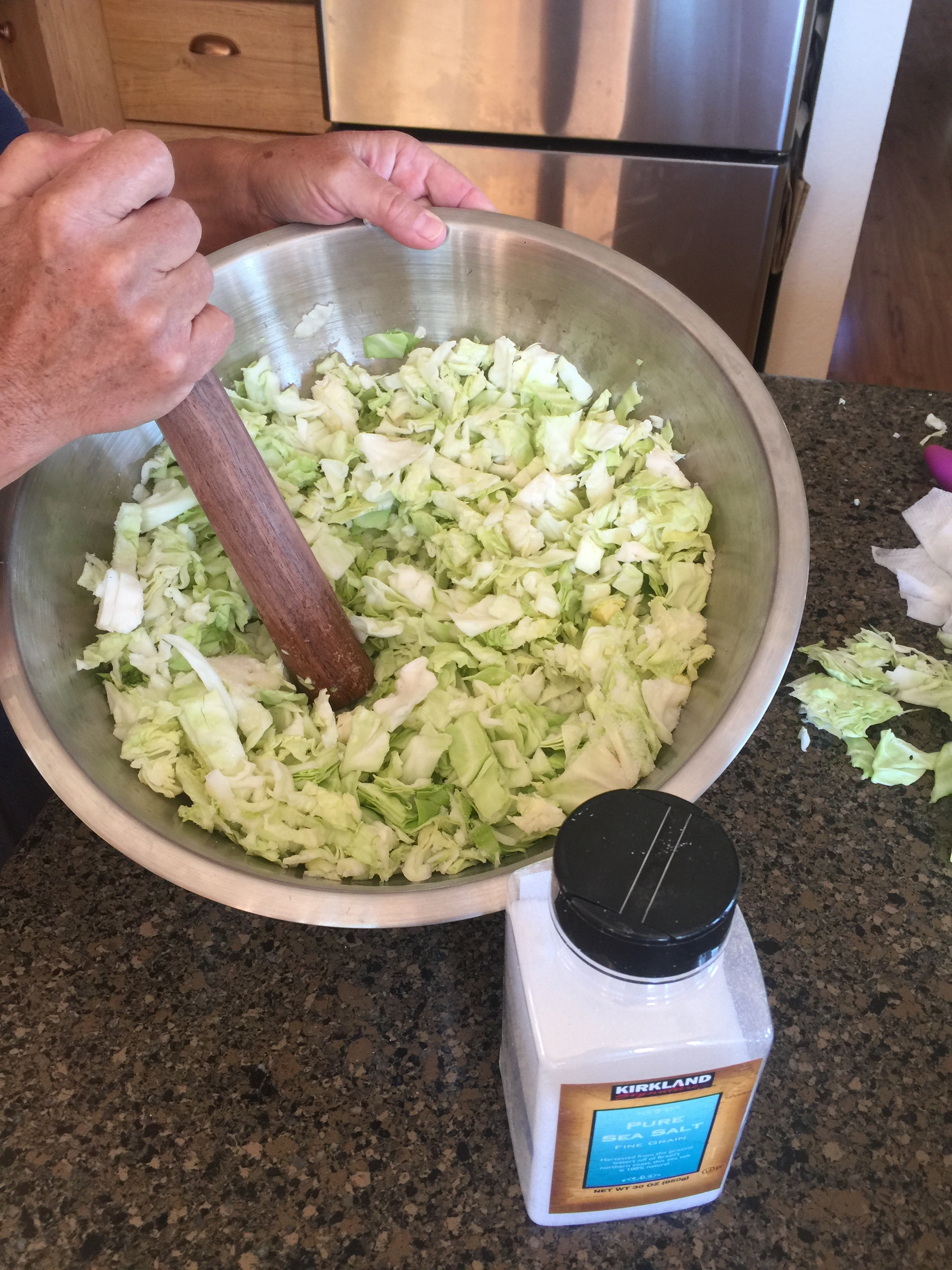Pounding the cabbage and salt. 
