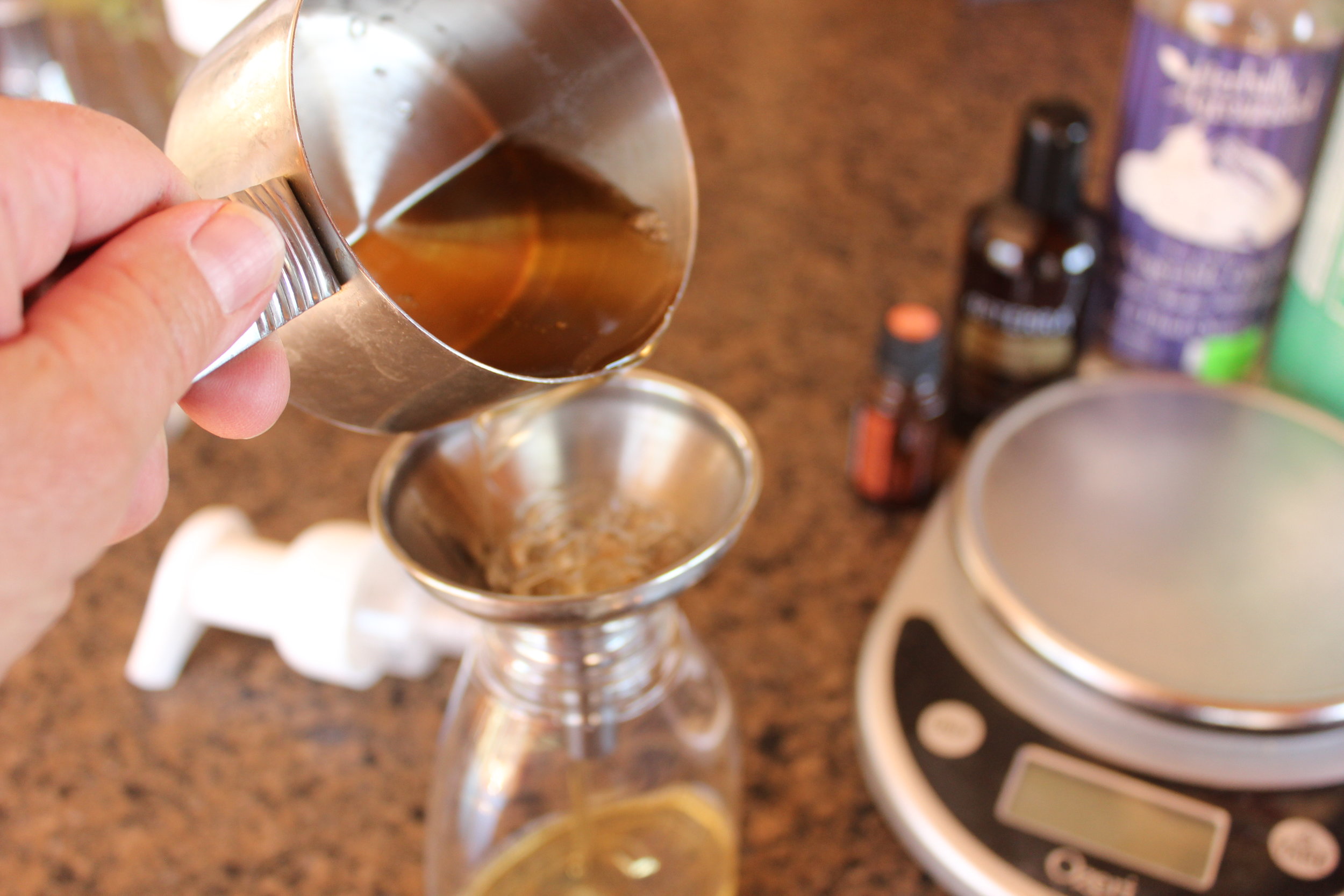 Pouring everything into the bottle. You can see the kitchen scale there. I do use it once in awhile, but you really don't have to for this. I usually don't measure at all, but I thought I'd better since this is going in a post. lol! 