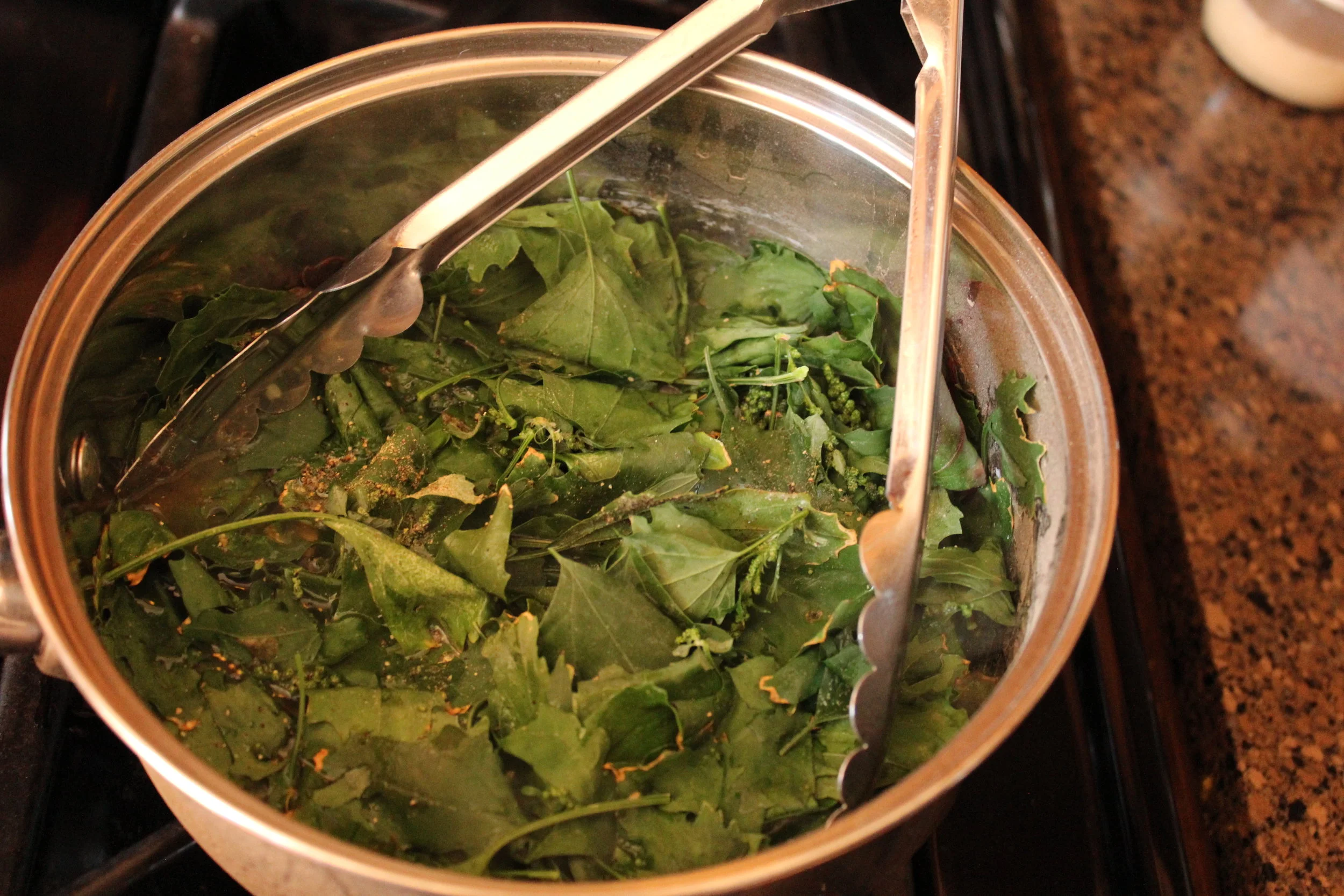 Cover and steam them down with water, salt, and pepper. These have been cooking for about 2 minutes. I ended up cooking them for about 10 minutes total, before they looked just like cooked spinach. 