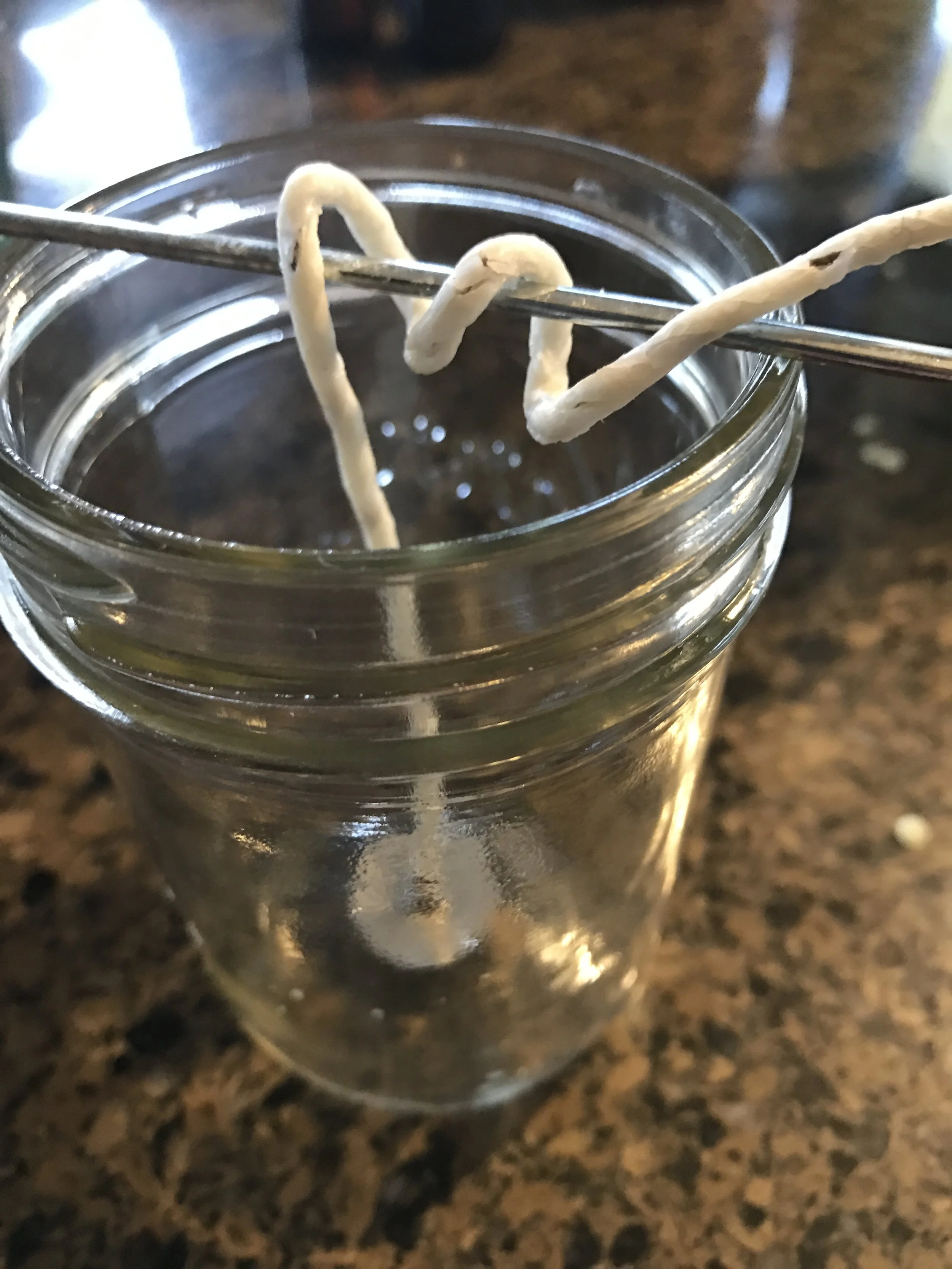 Here is the wick twirled around the skewer to keep it straight in the jar.