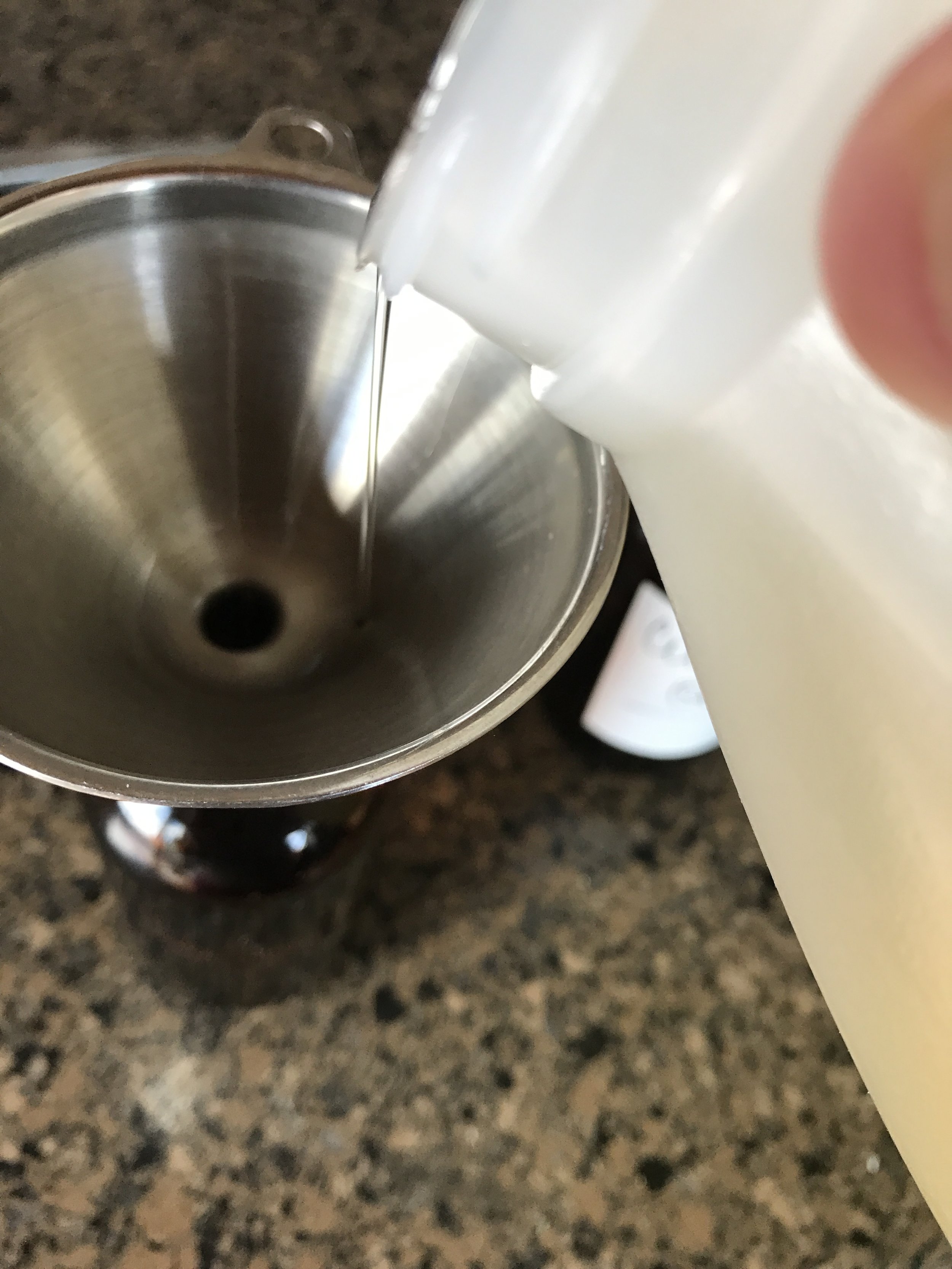 Pouring the almond oil into the jar with the essential oils. I use a funnel because it makes it a LOT less messy!