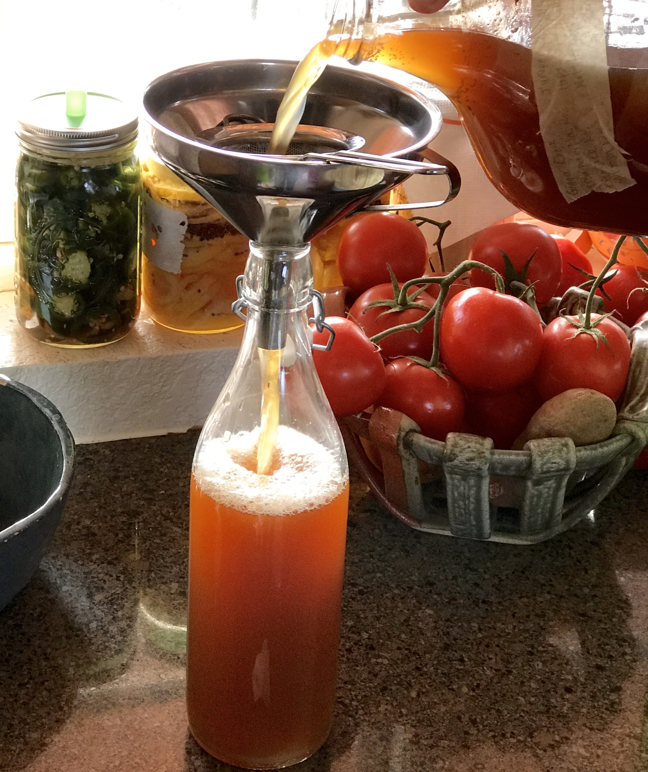 Filling the bottles with the fermented herbal beer. It's already a bit foamy!