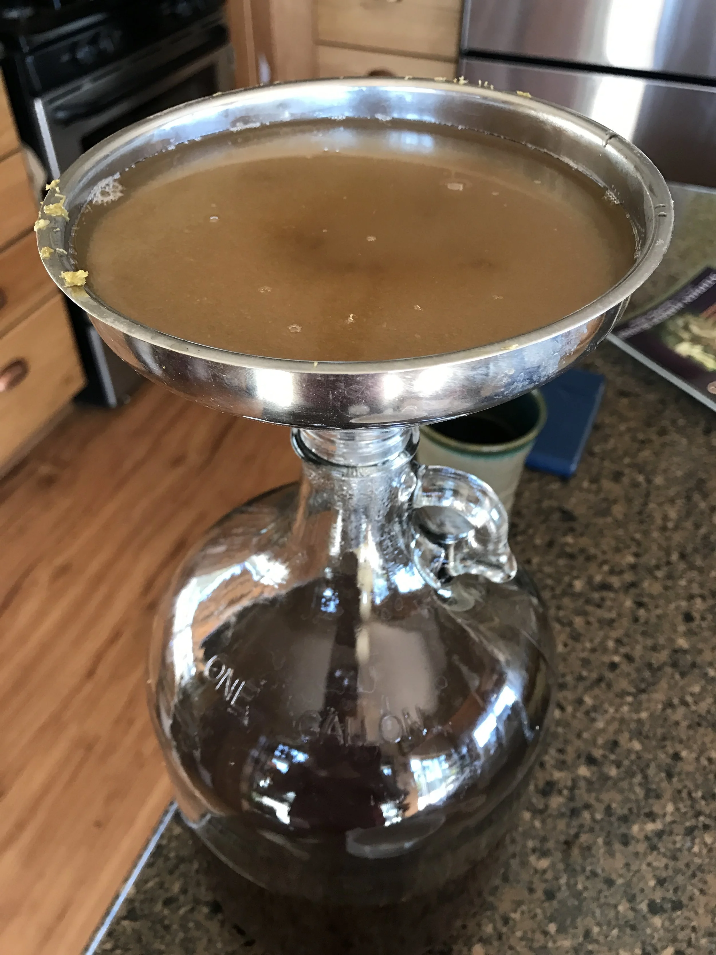 Here I'm adding the sugar. The funnel was wet, causing the sugar to stick, so I'm adding a bit of water to get it to move on down the funnel opening.