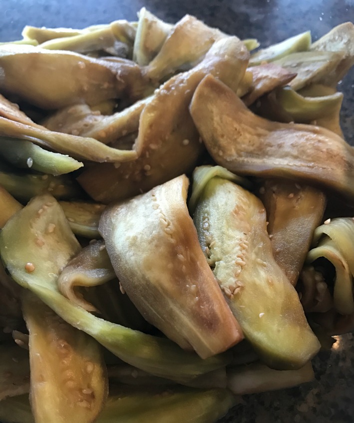 Here are the sliced eggplant. They've been sliced, massaged with some salt, and allowed to sit for about 30 minutes. This really softens them up and releases the juices! It really helps the ferment for this vegetable.