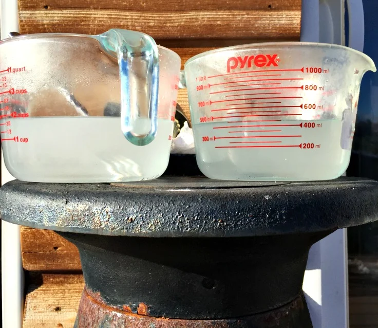 Here's lye solutions cooling down outside. I usually make two batches at a time in two crock pots dedicated to making hot process soap!