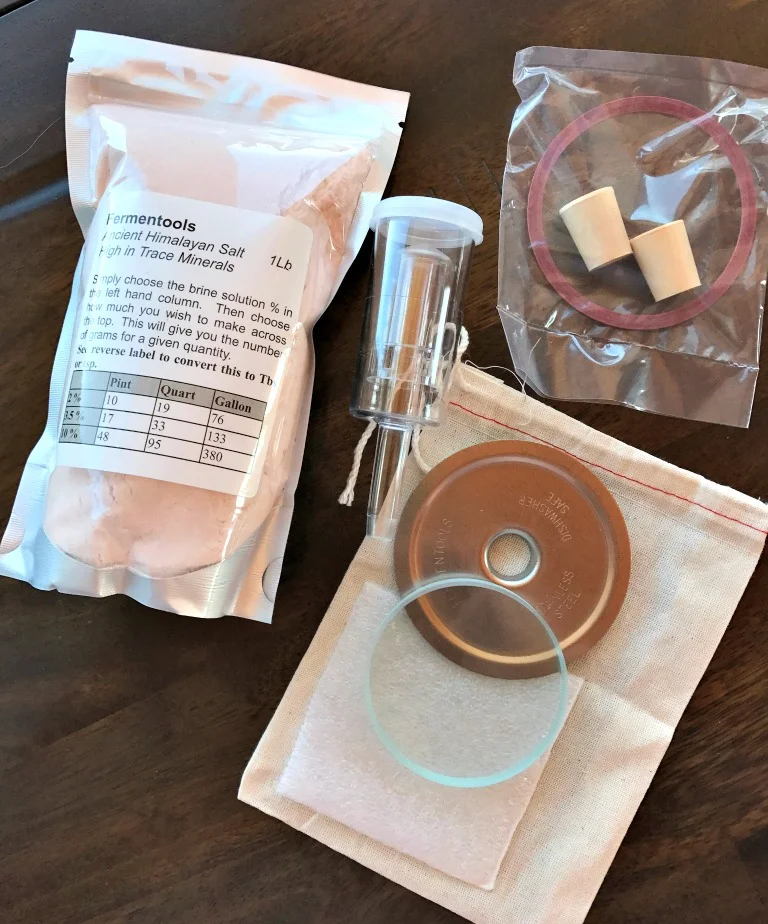 The Fermentools Starter Kit: A soda lime heavy glass weight, a stainless steel Mason jar lid with gasket, an airlock with bung to fit the lid, and the most amazing salt ever! 