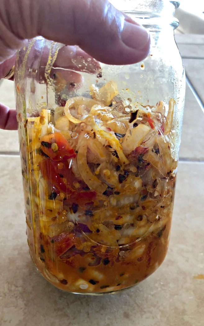 Here's how much the veggies reduced, and you can see the brine starting to form!