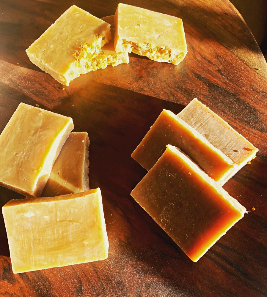 Here are three different milk soaps made using the hot process method. The one on top is coconut milk soap. I did color it with a little turmeric, or it would have been a bit lighter. The one on bottom right is a buttermilk and honey soap. Honey tends to darken soaps a bit, too. The one on the left is a buttermilk, honey, and vanilla oatmeal soap. It’s quite a bit darker, and this is due to the vanilla extract.