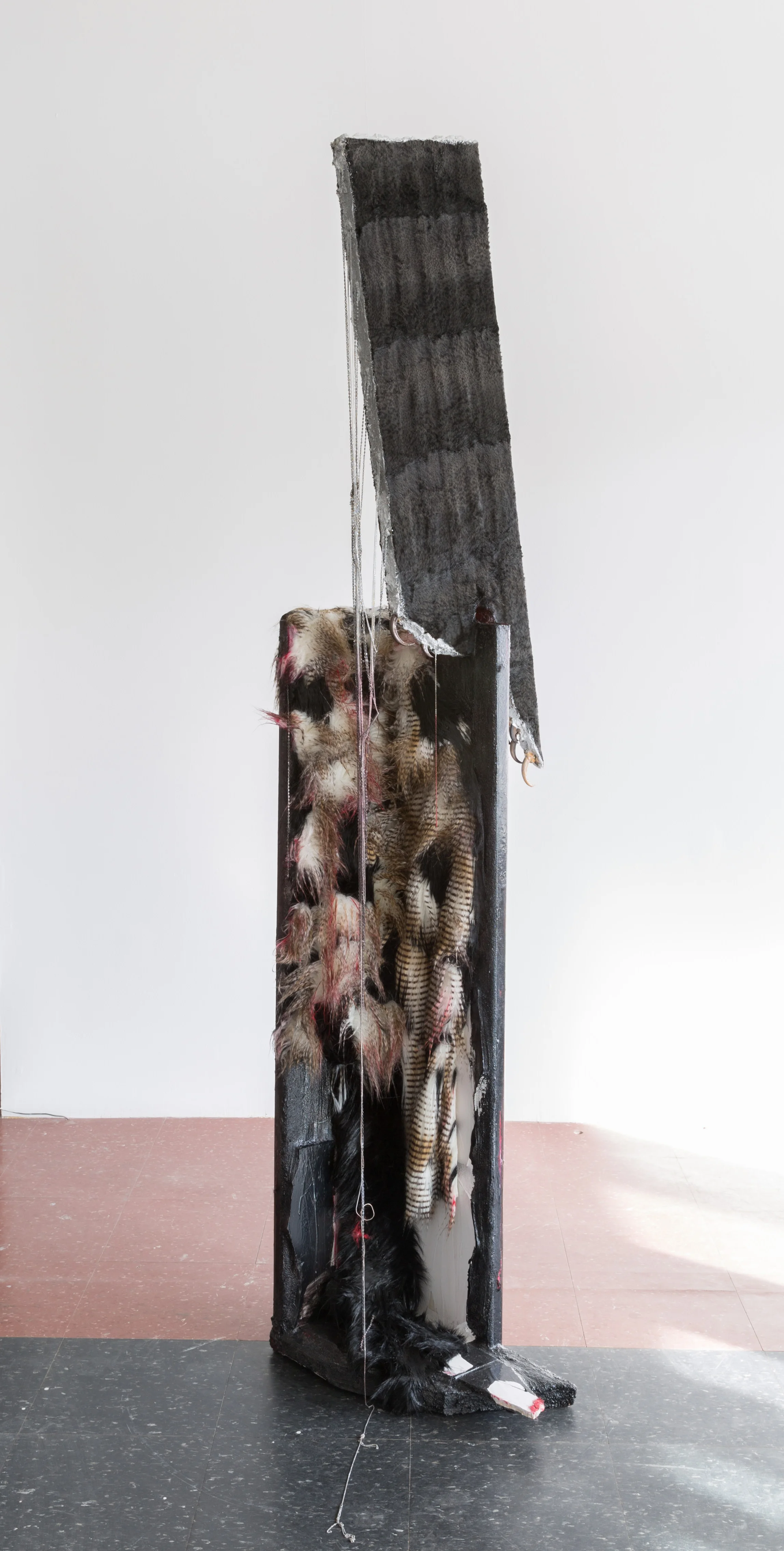 TOTEM VII , 2016 concrete, Carrara marble, grout, metallic stain, necklaces, faux pony fur, museum quality replicas of bald eagle talons and bear claws, red lipstick, wood, black nail polish 78 x 18 x 2 in