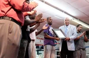 Commissioner Bill Fennoy presents Ray Whitfield with a proclamation honoring the Augusta Boxing Club's 40th anniversary.