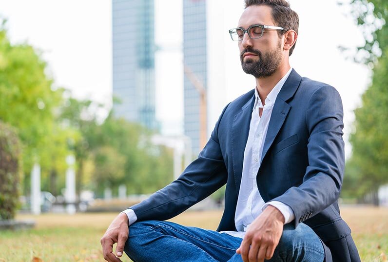 Businessman Meditating in a Park at Lunchtime
