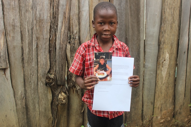 Ian with photo and letter.JPG