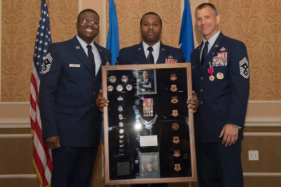 Presented with his shadow box by fellow wingmen. 