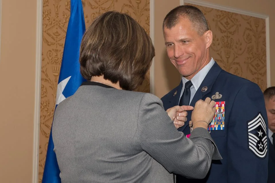 Pinning his retirement pin. I love how he's looking at me. I'm pretty sure I just said, "I can't see what I'm doing--I don't have my glasses on!"