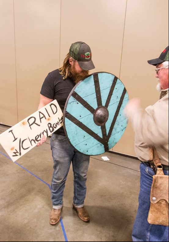 Jon E Bravo admires shield.