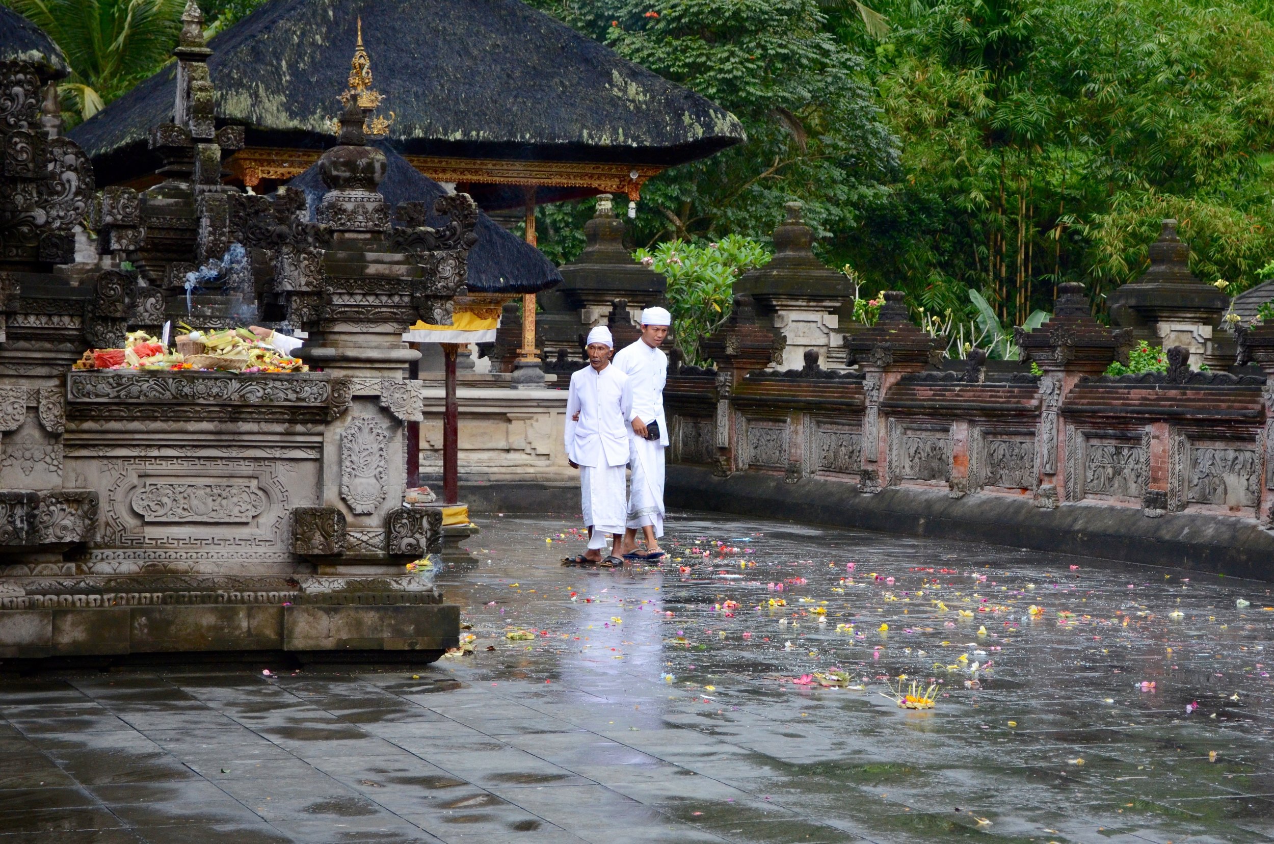 Priests among the colourful offerings after a ceremony at Tirta Empul, a water temple near Ubud, Bali.