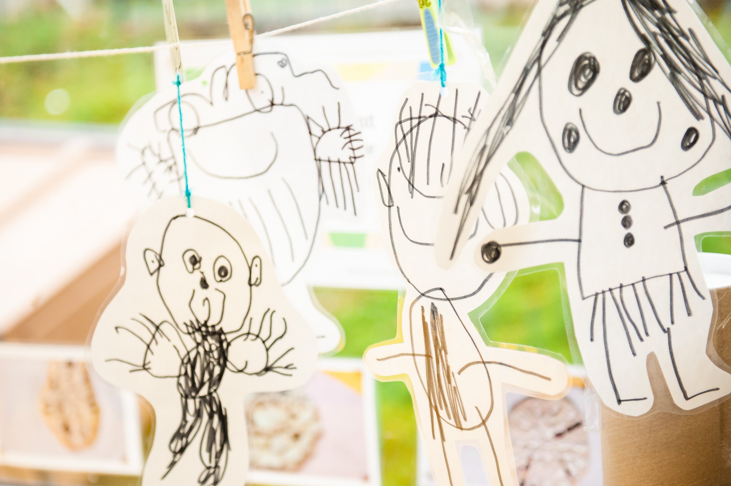 stick figure drawings hanging in classroom