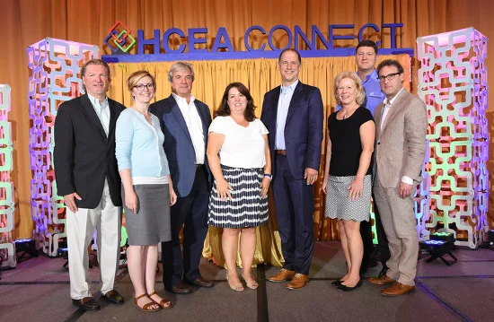 Pictured, left to right: Don Schmid, Past President, HCEA; Jeannie Wert, Vice President, HCEA; Kyle Wood, President, HCEA ; Amy Lotz, Executive Director, HCEA; Randy Acker, President, Chief Operating Officer, Exhibitor Media Group; Sue Huff, Treasurer, HCEA; Sean Feehan, Secretary, HCEA; Gregg Lapin, President-Elect, HCEA.