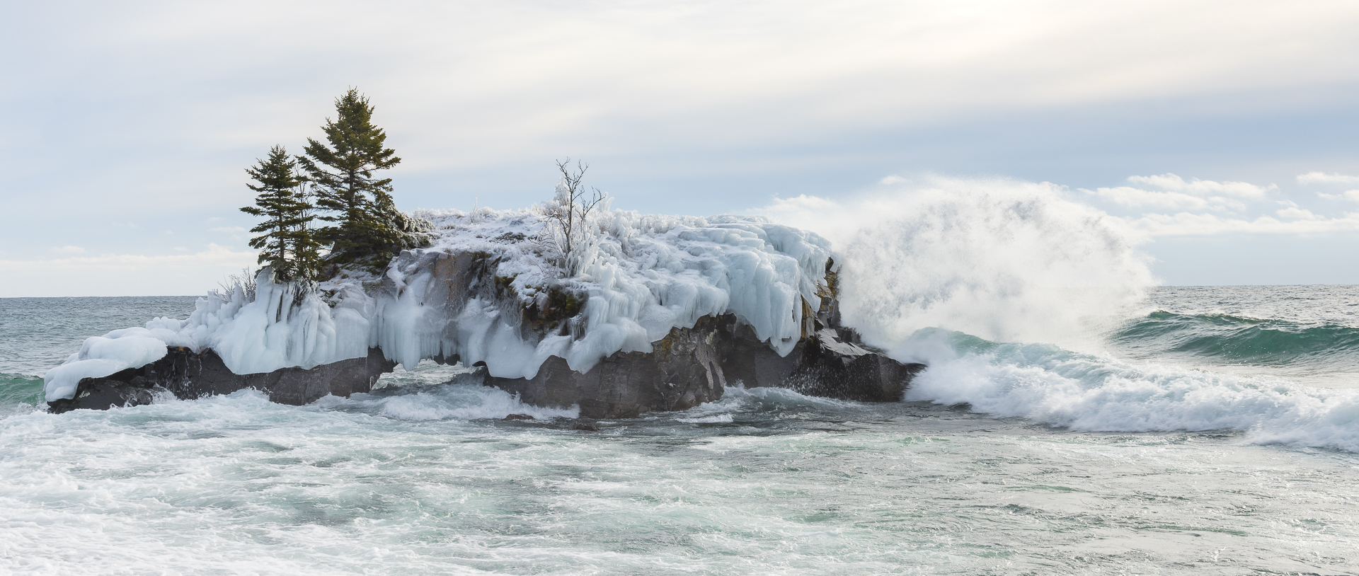 Winter waves pound Hollow Rock, MN.