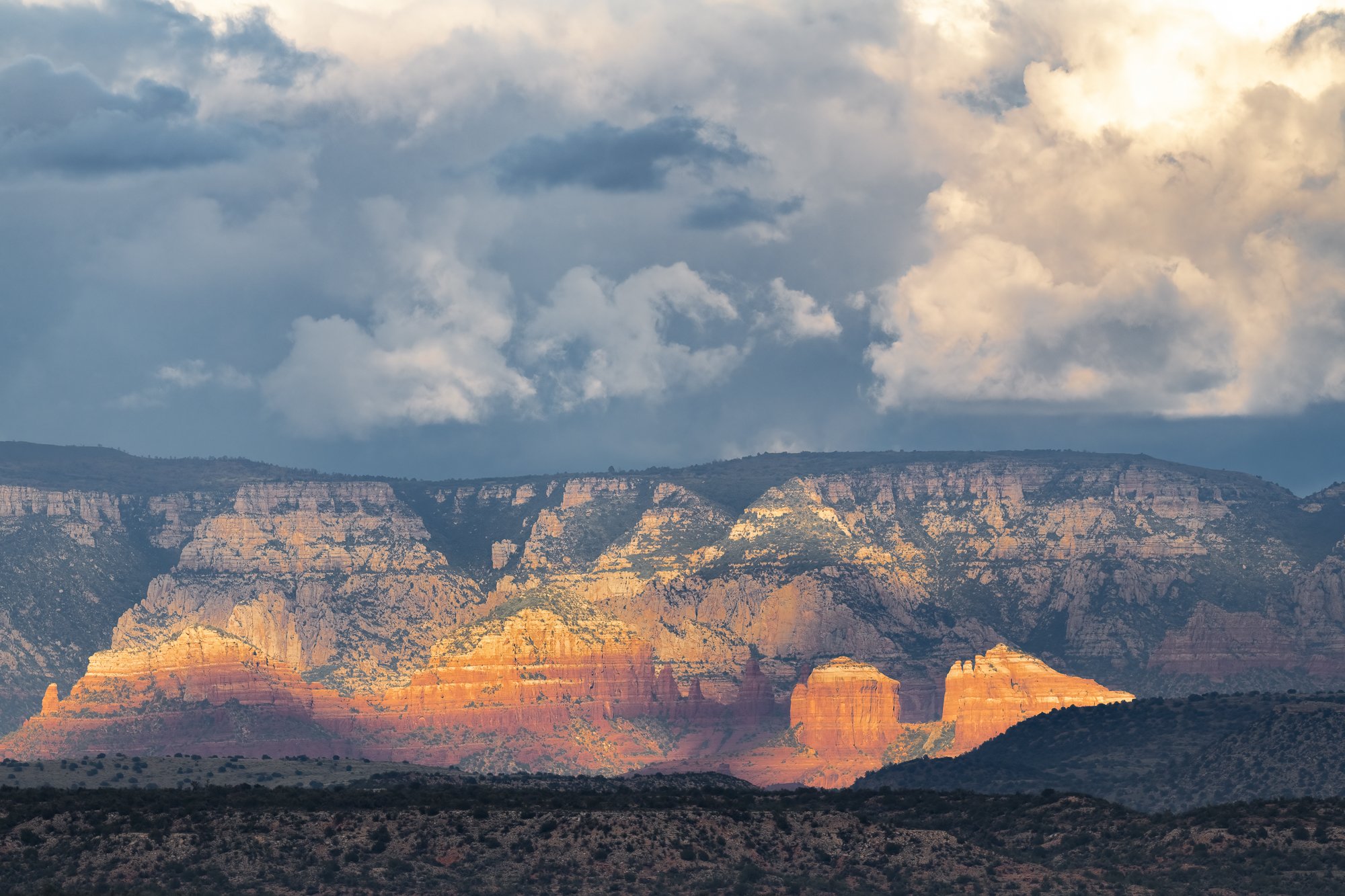 Late afternoon monsoon clouds over red rock formations