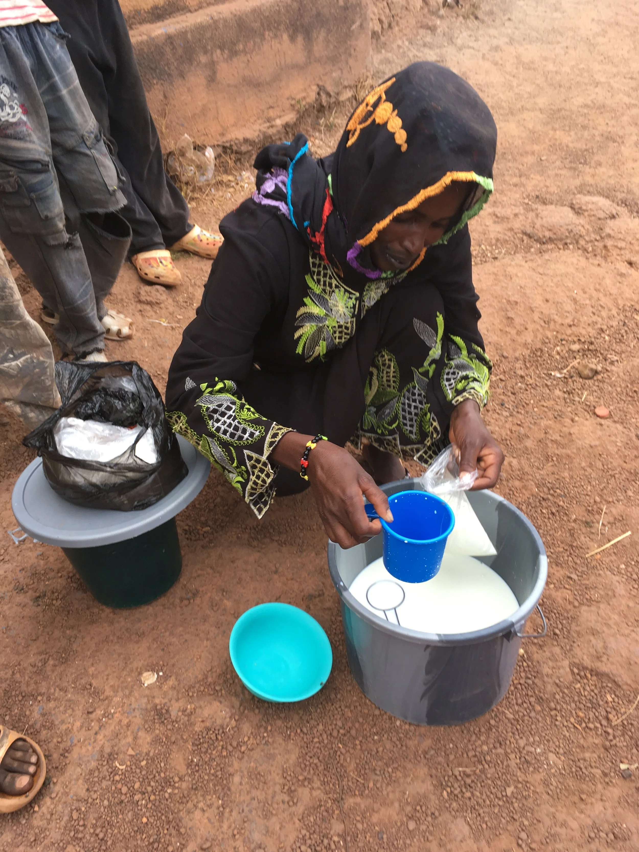 Buying milk at the market in Mali.