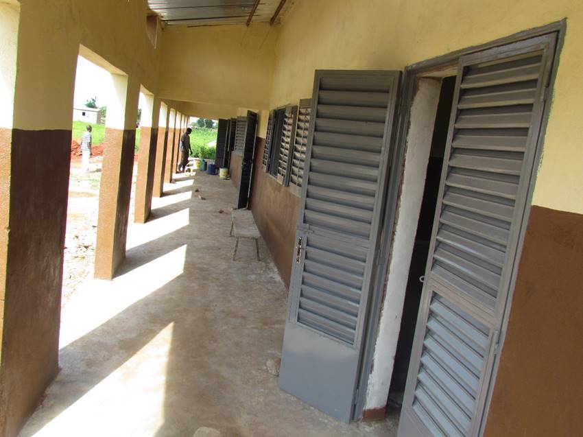  A view down the shady veranda connecting the three classrooms. Doors and windows are made of metal slated panels to encourage airflow.&nbsp; 