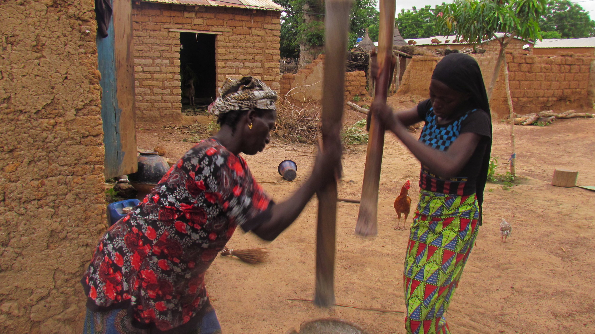  Adiaratou pounding millet with her mother. 