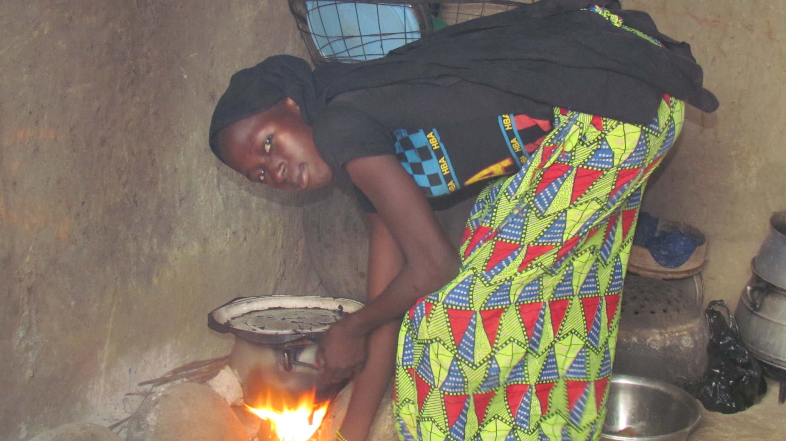 Household chores for girls like Adiaratou are a constant pressure. Here, she cooks a meal for the family. 