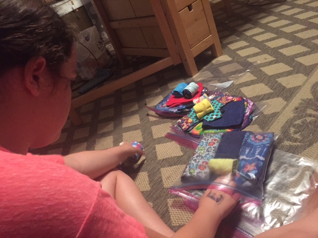  Skyler stuffing the final kits with shields, pads, underwear, washcloths, and more. 