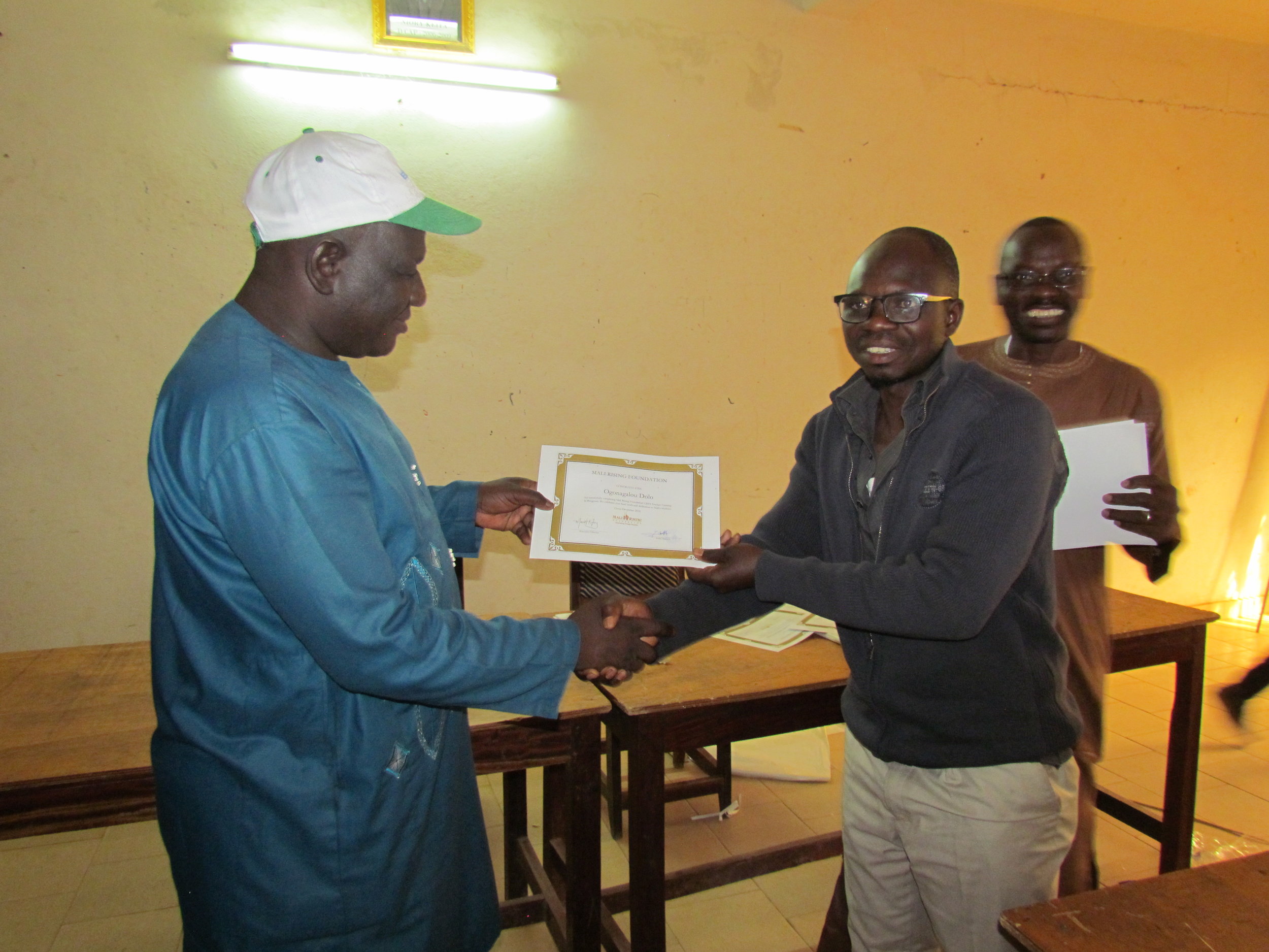Bougouni CAP director giving to a teacher his certificate.JPG
