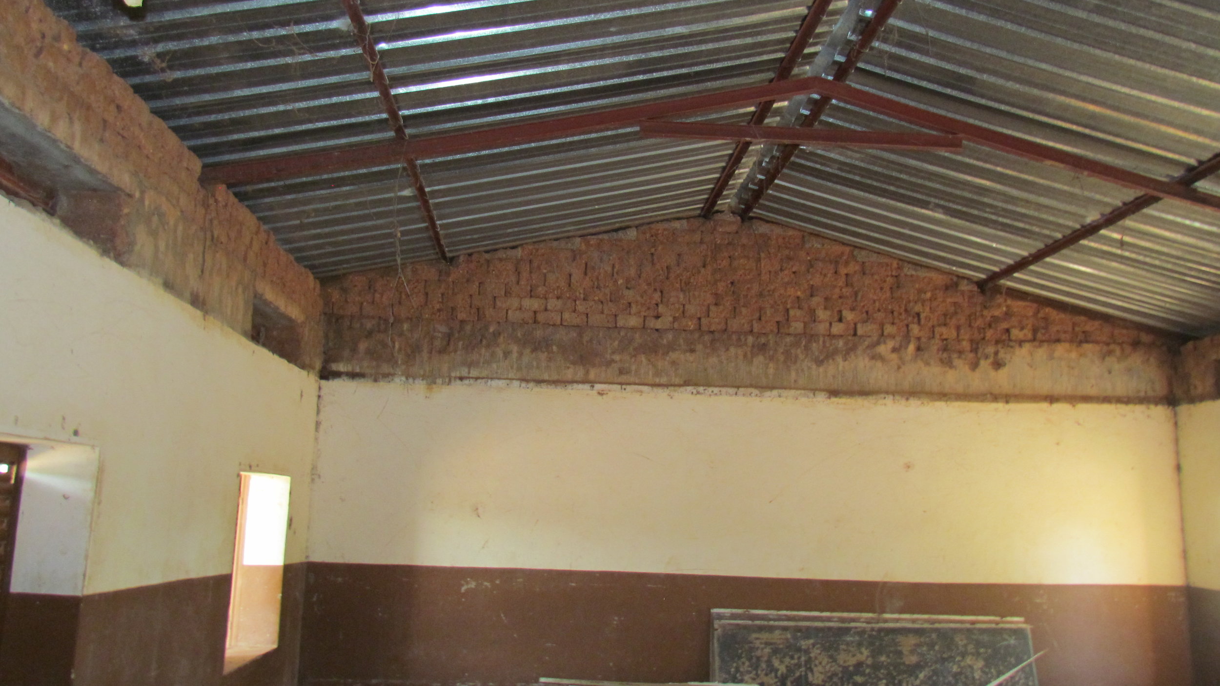 Inside a repaired classroom, after the removal of the bat infested ceiling but before replastering.