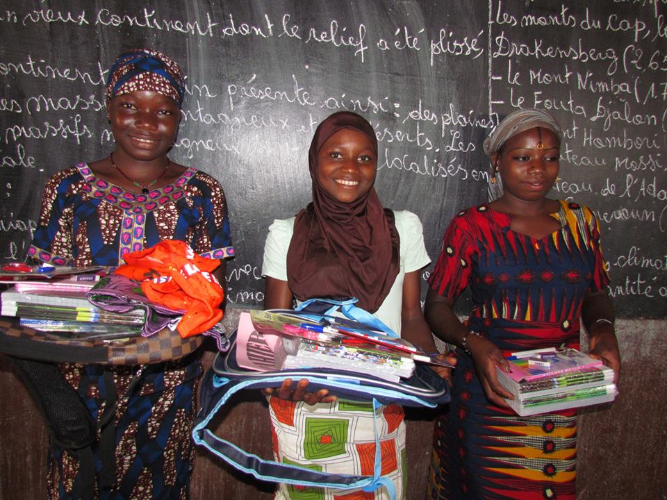 Siraba with school supplies she won for being top girl last year.