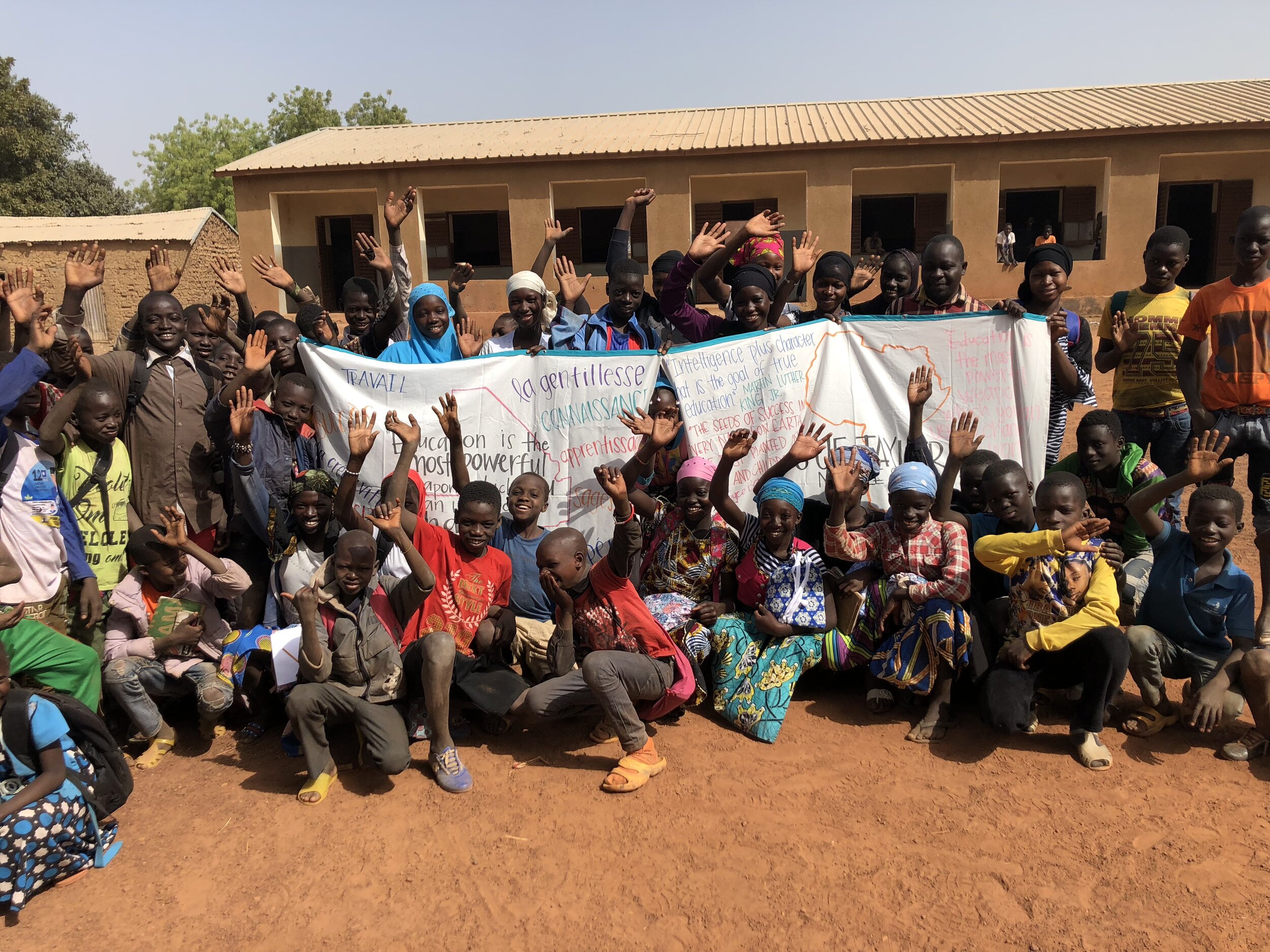 Students of Diorila with banners made for them by Mali Rising volunteers.