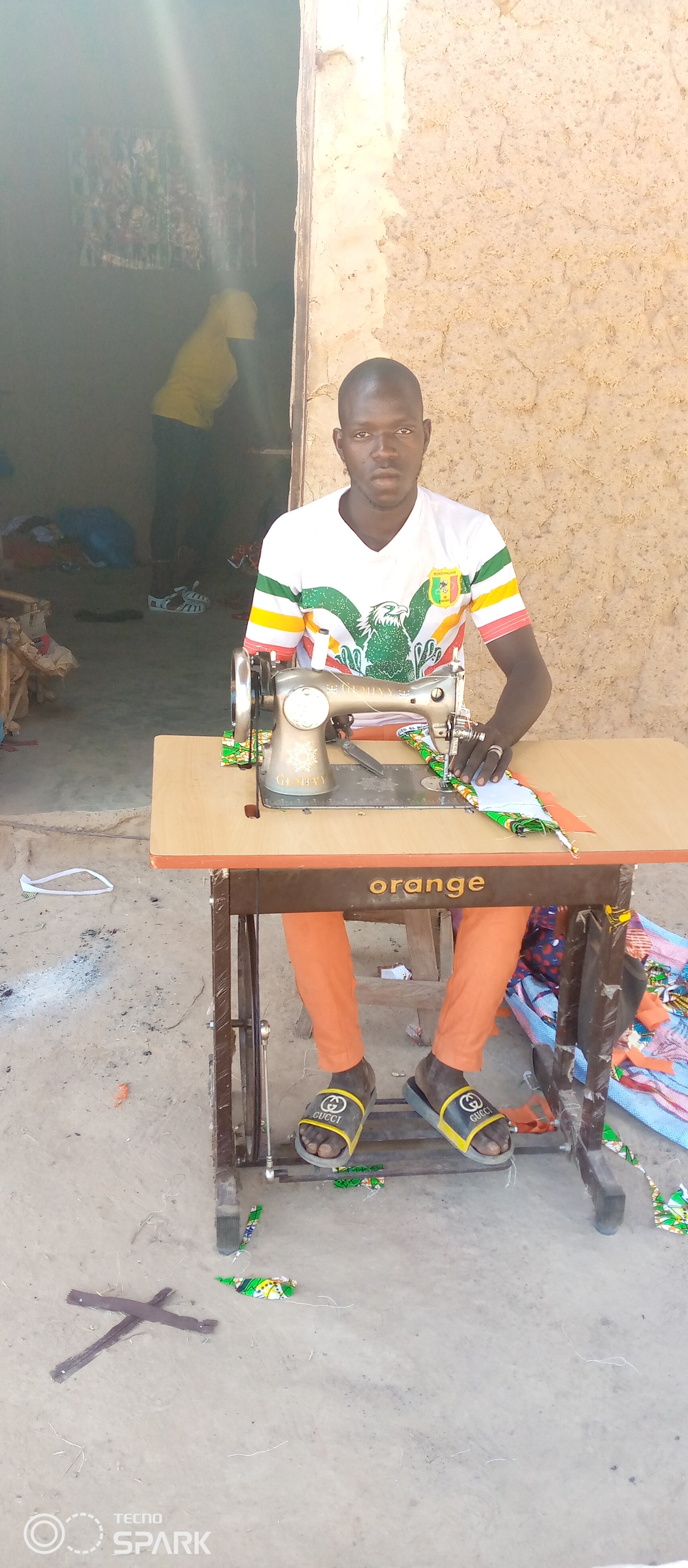 The young village tailor, who was forced to drop out of school because N'Goko did no have a school.