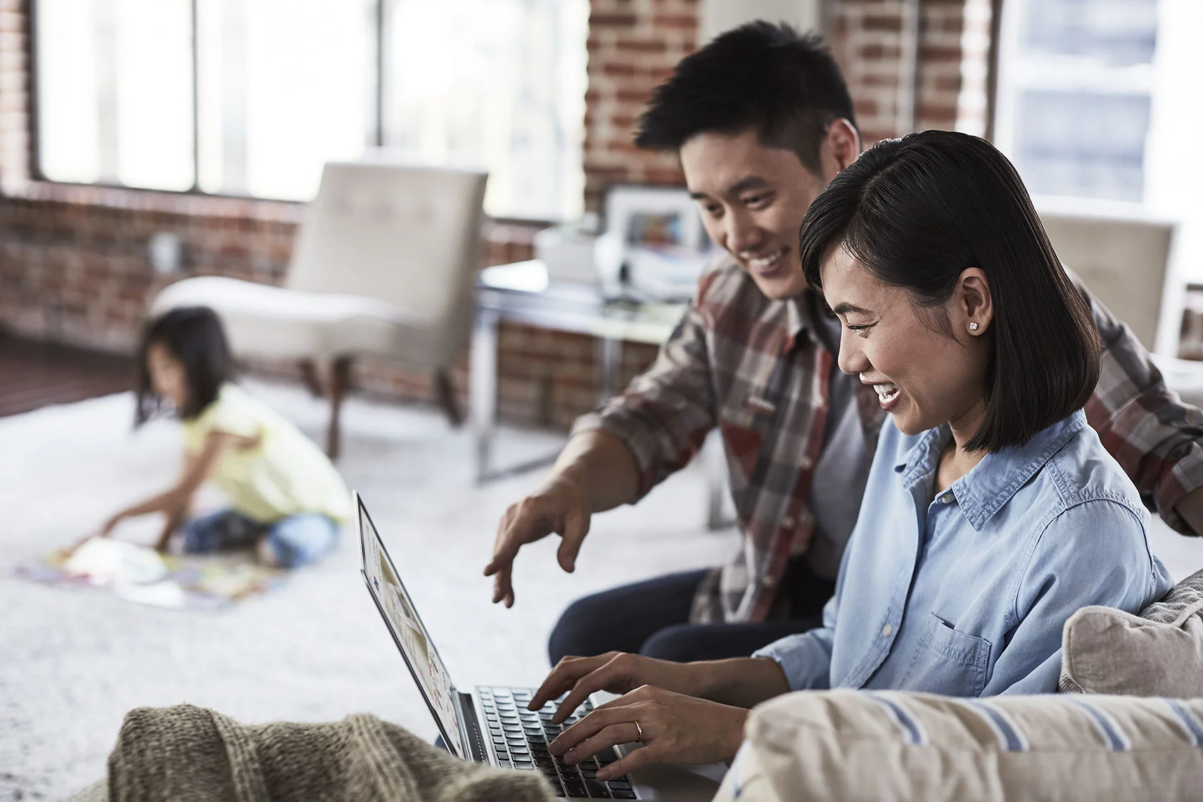 Jeremy-Frechette-Asian-couple-daughter-working-laptop.jpg