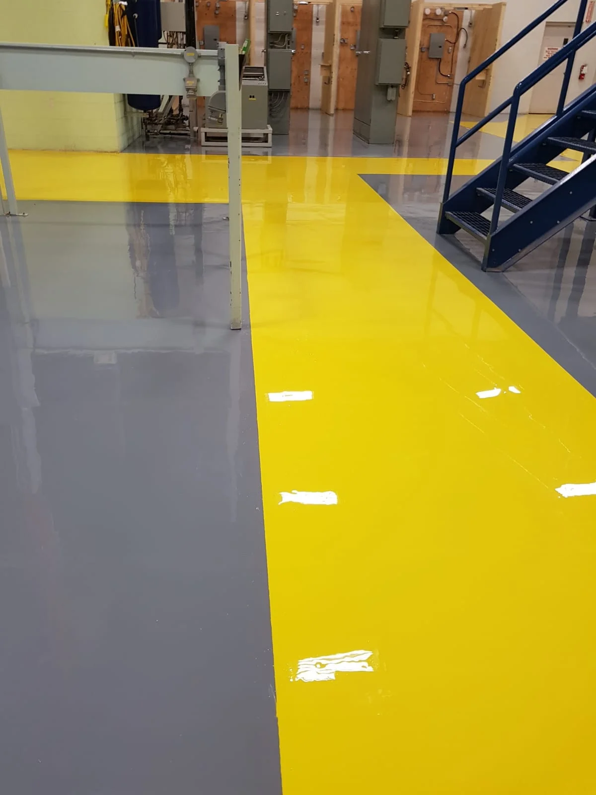 Epoxy Coating with Safety Yellow walkway to keep pedestrians at a safe distance from machinery.