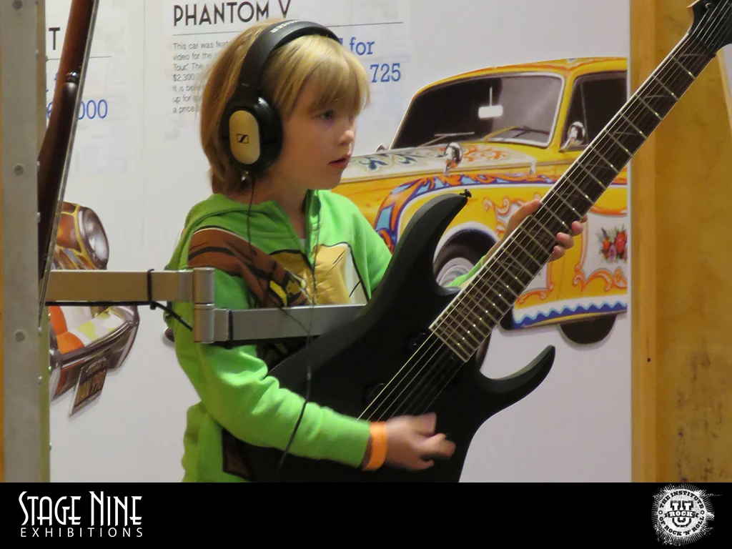 Exhibit_Photos_Rock_U_2016- First time playing a real guitar.jpg