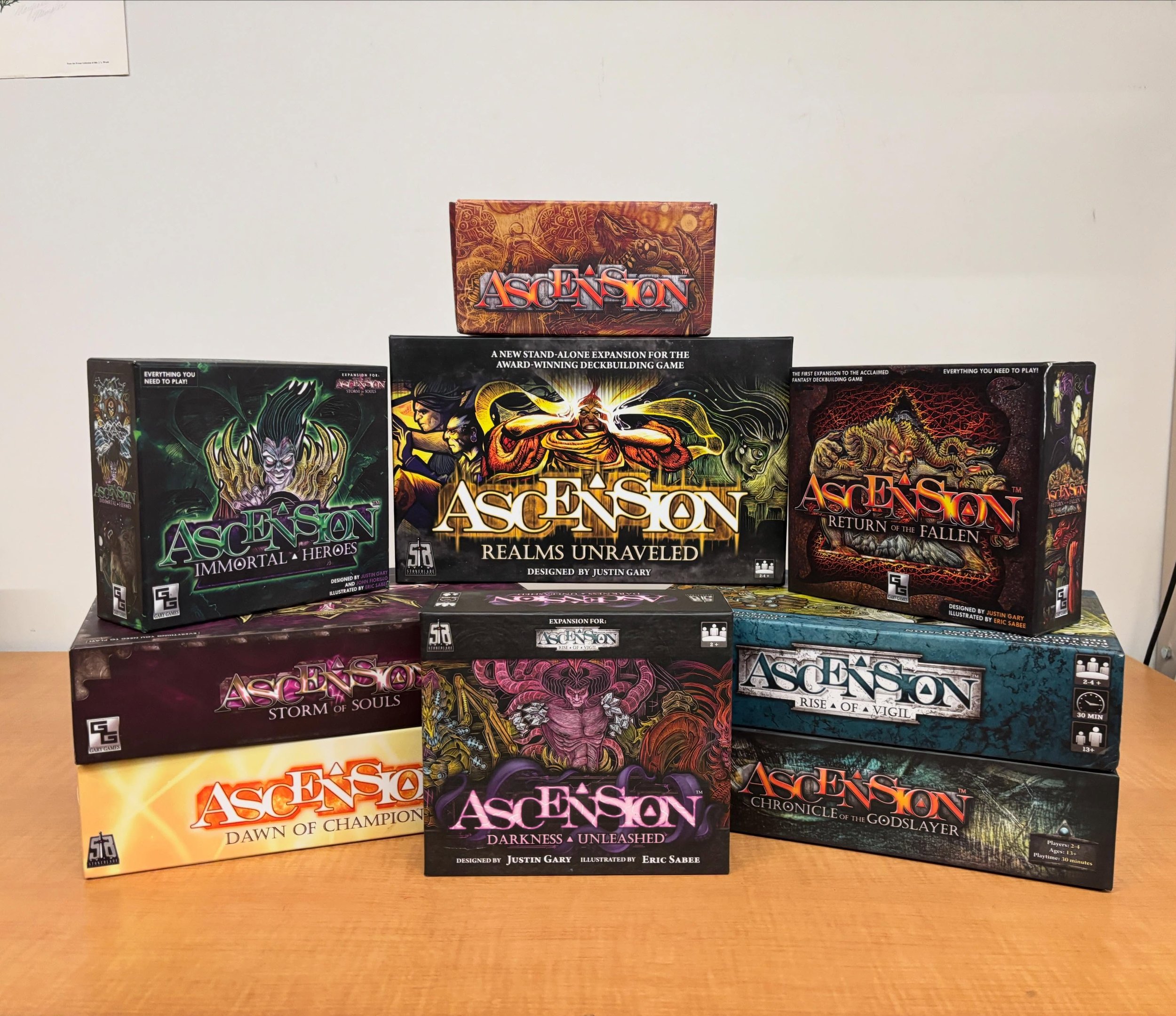 COLLECTORS CORNER FEATURE OF THE WEEK: Ascension deckbuilding game set! Contains original release of the base game Chronicle of the Godslayer, the first 7 expansions, 6 promo packs, branded sleeves and a deckbox. Designed by Justin Gary. Condition va