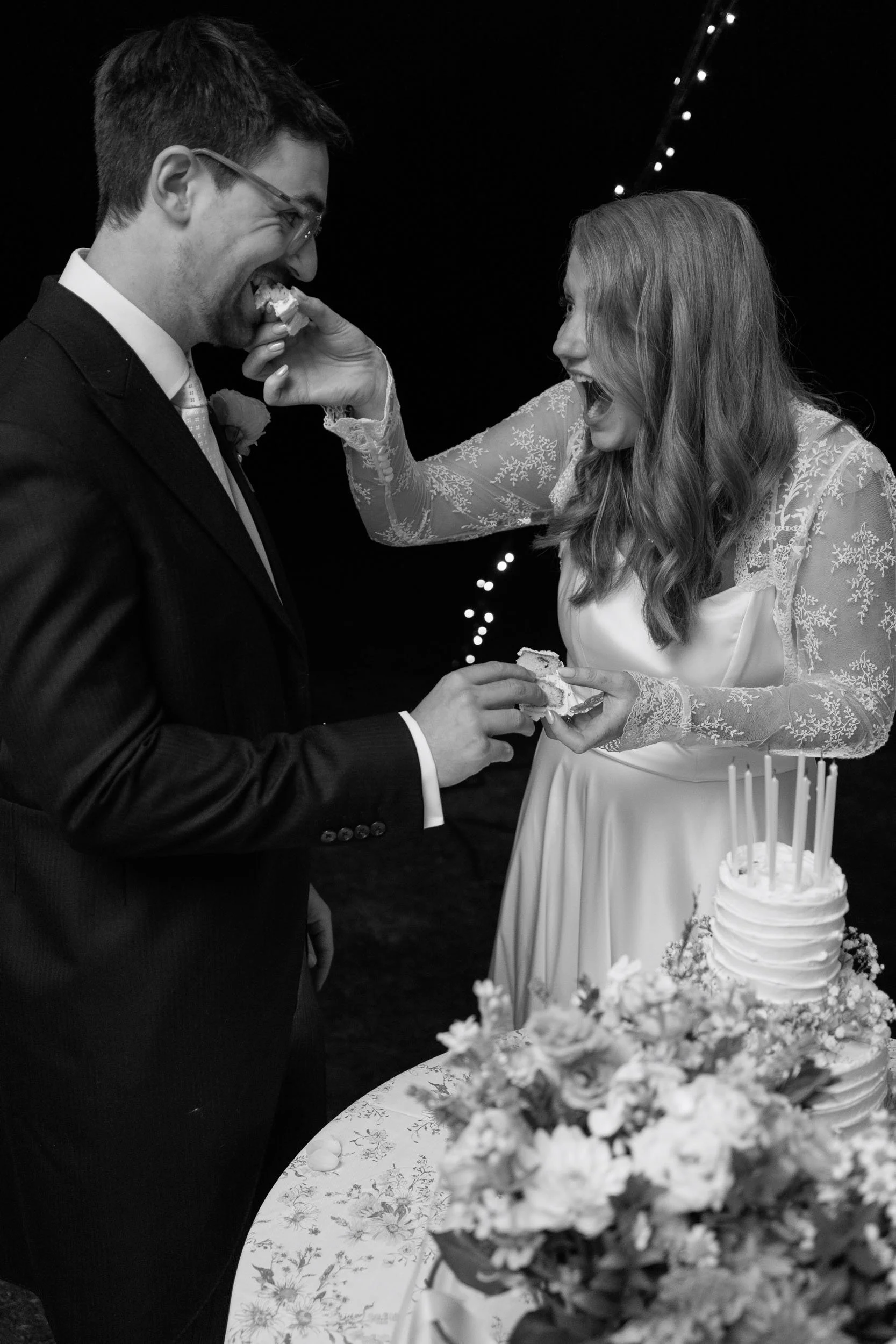 Clemmie and James cutting their wedding cake during the evening reception