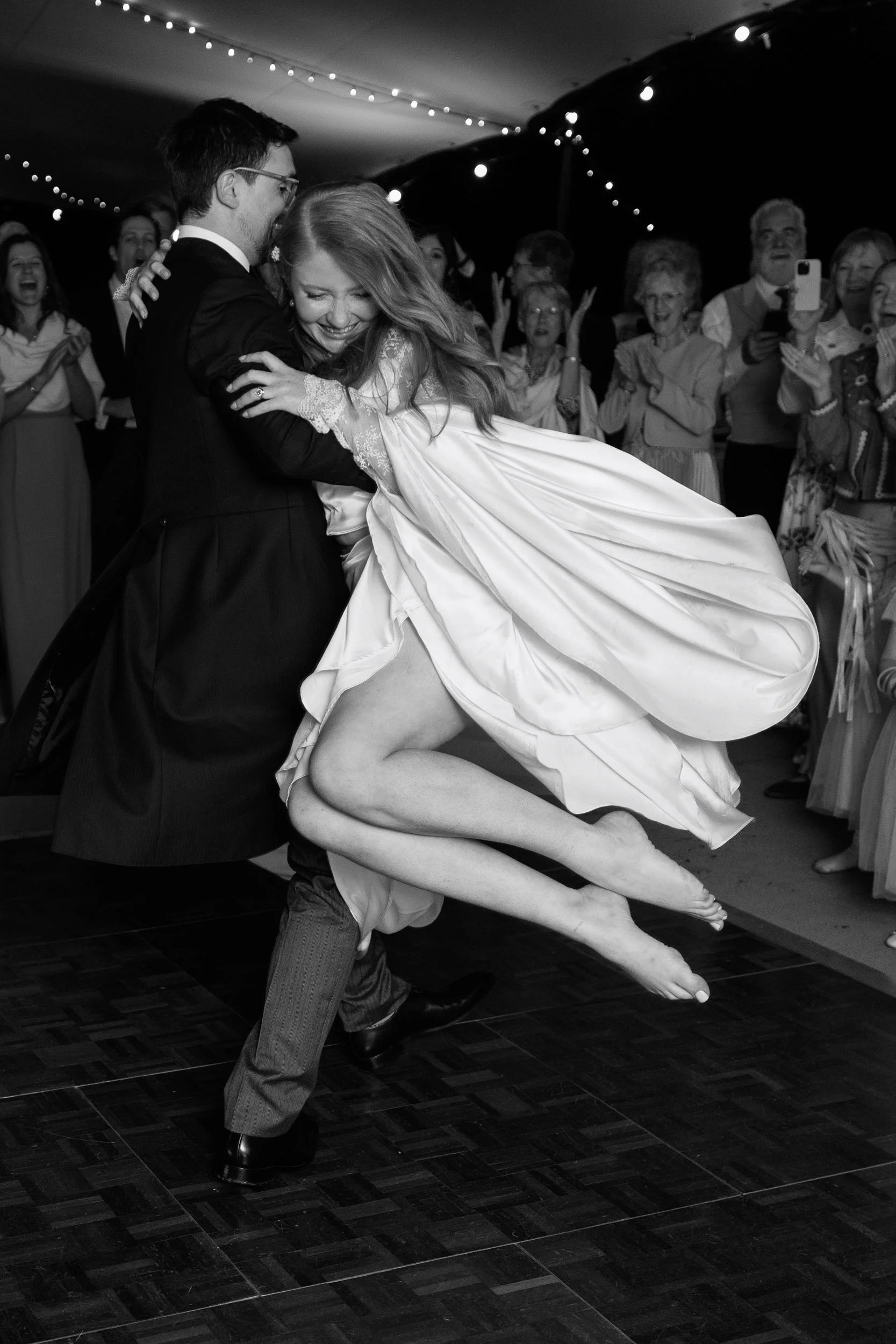Clemmie and James dancing with guests at their wedding reception