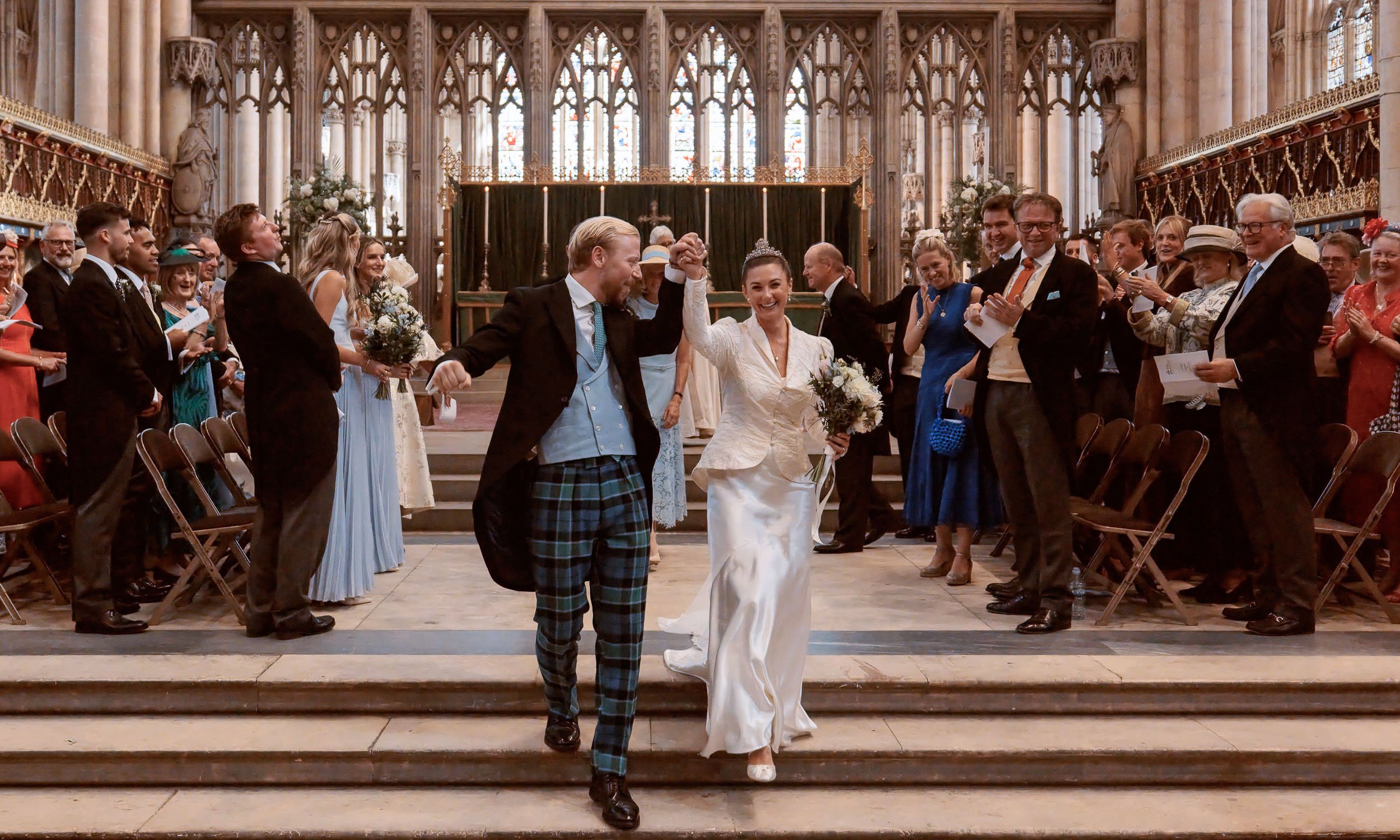 Alicia and Max celebrating inside York Minster following their wedding ceremony.