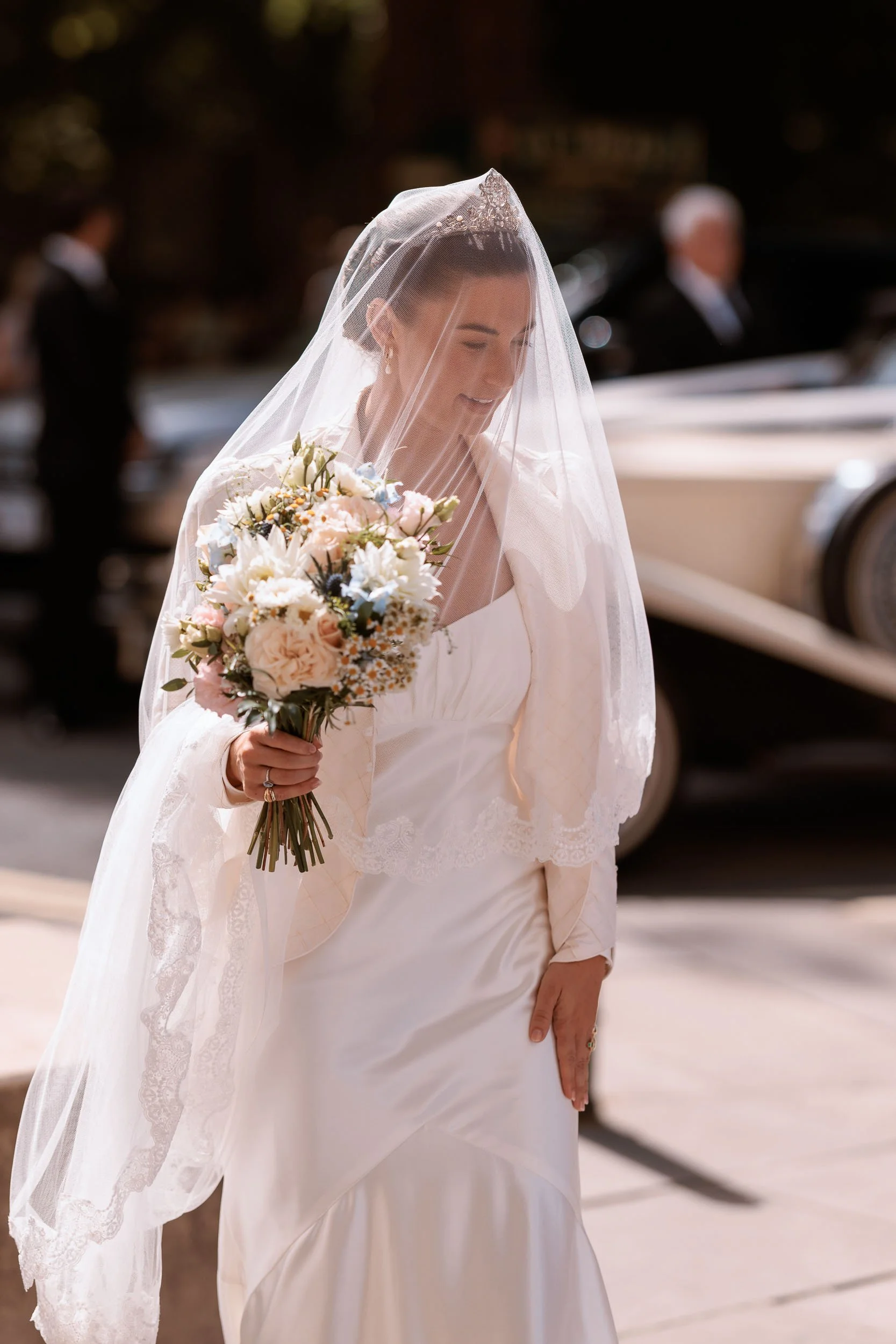 Alicia arriving for her York Minster wedding with her bridal veil catching the light.